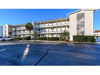 Low-rise condo building with ample parking and well-manicured landscaping at 1919 Spring St. # A-16, North Myrtle Beach, SC 29582