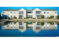 Two-story condo building with water view and landscaping at 2225 Essex Dr. # F, Surfside Beach, SC 29575