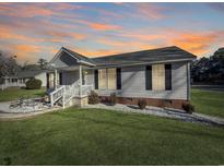 Ranch style home with gray siding, brick accents, and a landscaped yard at 2271 Sterritt Swamp Rd., Conway, SC 29526