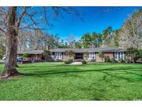 Brick ranch house with large lawn and mature trees at 3173 Long Avenue Ext., Conway, SC 29526