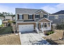 Two-story house with a white front porch, two-car garage, and landscaped yard at 327 Simplicity Dr., Murrells Inlet, SC 29576