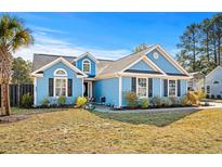 Beautiful light blue house with dark accents, nicely landscaped yard at 3836 Journeys End Rd., Murrells Inlet, SC 29576