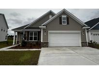 Charming home with a two-car garage and neatly landscaped front yard at 4040 Bucolic Loop, Myrtle Beach, SC 29588