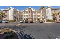 Brick building exterior with parking lot and landscaping at 4809 Luster Leaf Circle # 102, Myrtle Beach, SC 29577