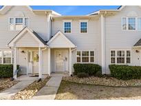 Two-story townhome with light-colored siding, landscaping, and walkway at 618 3Rd Ave. S # 4B, North Myrtle Beach, SC 29582