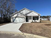 White brick home with gray door and two-car garage at 640 Carter Reid Ct., Conway, SC 29526