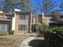 Attractive townhome exterior with landscaping and walkway at 800 Egret Circle # 45, Little River, SC 29566