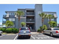 Gray building exterior with parking and oceanfront location at 1501 S Waccamaw Dr. # 1-D, Garden City Beach, SC 29576