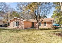Brick ranch house with a spacious lawn and mature trees at 1600 Gibson Ave., Myrtle Beach, SC 29575