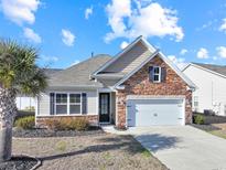 Charming one-story home with stone accents and a two-car garage at 191 Ocean Commons Dr., Surfside Beach, SC 29575