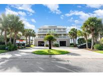 Attractive two-story home with circular driveway and palm trees at 2179 South Waccamaw Dr., Garden City Beach, SC 29576