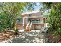 Two-story home with brick and siding exterior, a covered porch, and a landscaped yard at 245 Windover Dr., Pawleys Island, SC 29585