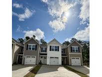New townhomes feature various neutral-colored exteriors and convenient attached one car garages in a friendly community at 265 Christiana Ln. # B, Myrtle Beach, SC 29579
