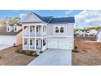 Two-story house with gray siding, white trim, and a two-car garage at 299 Empyrean Circle, Myrtle Beach, SC 29588