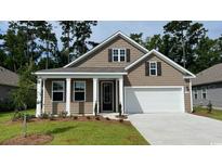 Attractive craftsman style home with front porch and landscaped yard at 384 Clear Lake Dr., Conway, SC 29526