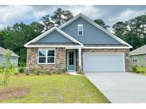 Charming single-Gathering home showcasing a stone facade and a well-manicured lawn at 392 Clear Lake Dr., Conway, SC 29526