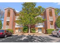 Brick building exterior with parking and landscaping at 4251 Villas Dr. # 303, Little River, SC 29566