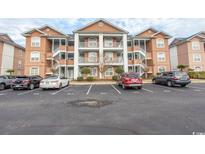 Three-story condo building with parking and landscaping at 4617 Lightkeepers Way # 9-I, Little River, SC 29566
