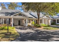 Brick front exterior of charming home with covered entry and landscaping at 489-3 Golden Bear Dr. # 3, Pawleys Island, SC 29585