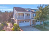 Two-story townhome with brick facade, balcony, and attached garage at 502 Hay Hill Ln. # B, Myrtle Beach, SC 29579