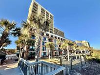 Beautiful exterior shot of a resort, showcasing palm trees and ocean views at 6900 N Ocean Blvd. # 1234, Myrtle Beach, SC 29577