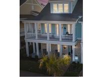 Charming two-story home featuring double porches and coastal-inspired blue siding at 8050 Yamassee St. # A, Myrtle Beach, SC 29572