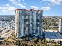 Aerial view of a high-rise building with oceanfront location and pool at 8500 Margate Circle # 606, Myrtle Beach, SC 29572