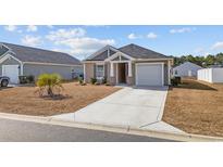 Charming single-story home with a well-manicured lawn and a one-car garage at 141 Foxford Dr., Conway, SC 29526