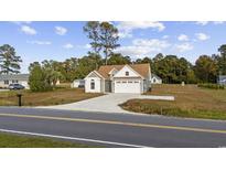 Newly constructed home with a two-car garage and landscaped yard at 1727 Cane Branch Rd., Loris, SC 29569