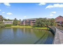 Building exterior showcasing a waterfront view and boardwalk at 180 Rothbury Circle # 215, Myrtle Beach, SC 29572