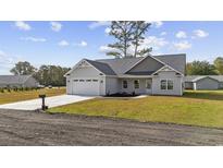 Newly constructed home with a two-car garage and landscaped yard at 1904 Blue Bird Rd., Loris, SC 29569