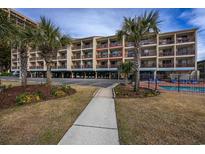 Oceanfront building, featuring a walkway, landscaping, and a pool at 202 75Th Ave. N # 5604/5605, Myrtle Beach, SC 29572