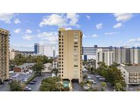 Aerial view of a high-rise building with a pool and ample parking at 210 75Th Ave. N # 4141, Myrtle Beach, SC 29572