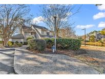 Exterior view of condo with landscaping and walkway at 215 Baslow Ct. # 1-B, Myrtle Beach, SC 29572