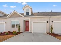 Two-story townhome with red door, attached garage, and landscaping at 3518 Bells Lake Circle # 215, Longs, SC 29568