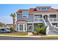 Attractive two-story townhome with gray siding, red roof, and landscaping at 4396 Baldwin Ave. # 34, Little River, SC 29566