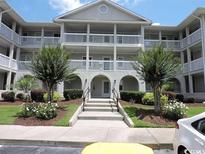 Two-story building with balconies and landscaping at 4430 Eastport Blvd. # L5, Little River, SC 29566