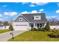 Two-story craftsman style home with gray siding, two-car garage, and landscaped lawn at 626 Notting Hill Ct., Conway, SC 29526