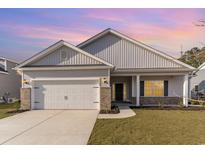 Newly constructed home with gray siding, a two-car garage, and a well-manicured lawn at 643 Woodside Dr., Conway, SC 29526