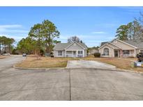 Charming single-story home with a well-manicured lawn and long driveway at 6716 Wisteria Dr., Myrtle Beach, SC 29588