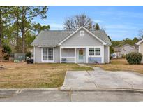 Charming single-story home with a manicured lawn, inviting entrance, and a gray exterior at 6716 Wisteria Dr., Myrtle Beach, SC 29588
