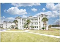 Beautiful condominium complex with manicured lawn and multiple floors with outdoor patios at 677 Tupelo Ln. # 301, Longs, SC 29568