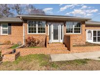 Brick ranch house with a spacious front yard and landscaped flowerbeds at 804 Geddings Dr., Myrtle Beach, SC 29588