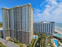 Aerial view of a luxurious beachfront highrise condo building with pools and ocean views at 9994 Beach Club Dr. # 1606, Myrtle Beach, SC 29572