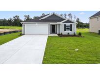 New construction home with gray siding, white garage door, and landscaped lawn at 1036 Kinness Dr., Conway, SC 29527