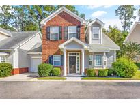 Two-story brick home with gray siding, shutters, and landscaping at 105 Terracina Circle # D, Myrtle Beach, SC 29588