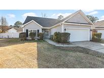 Charming single-story home with a well-manicured lawn and attached two-car garage at 1209 Peyton Ct., Myrtle Beach, SC 29588