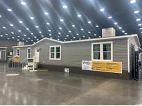 Exterior of a gray manufactured home with white trim and a gray foundation at 1375 Highway 139, Conway, SC 29526
