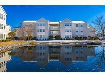 Beautiful condo building and pond reflect the clear blue sky creating a stunning view at 2268 Essex Dr. # L, Surfside Beach, SC 29575