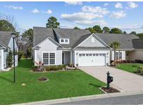 Charming single-story home with a well-manicured lawn, two car garage, and beautiful landscaping at 2450 Craven Dr., Myrtle Beach, SC 29579